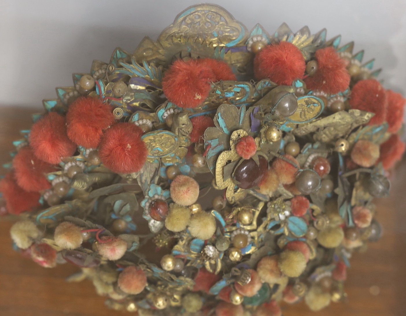A Chinese gilt metal, kingfisher feather and glass mounted lady’s wedding headdress, late Qing dynasty, decorated with phoenixes